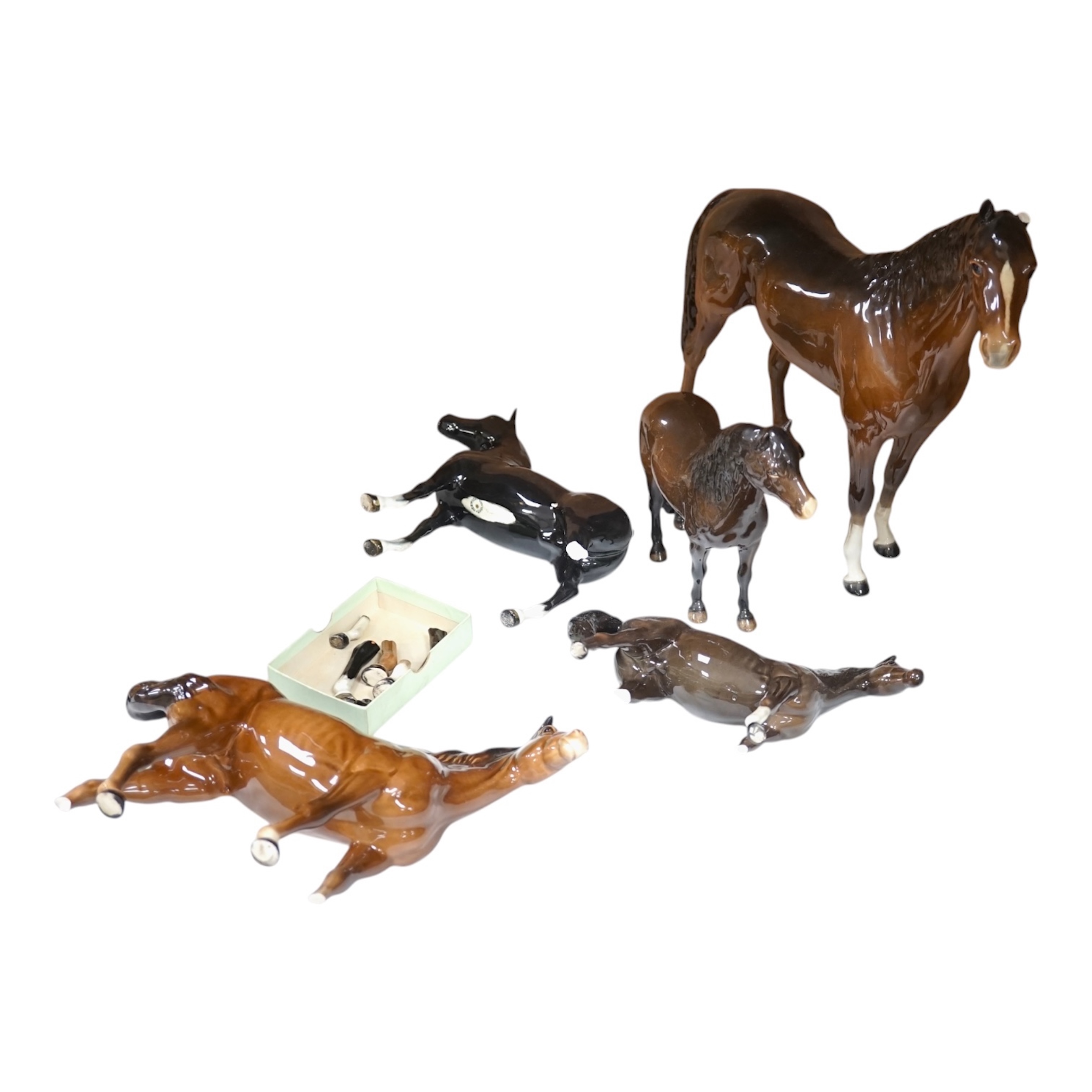 A large Beswick Chestnut horse, together with three other smaller horses and an Exmoor pony, tallest 30cm high (5). Condition - Exmoor pony good, all the others have broken legs or ears